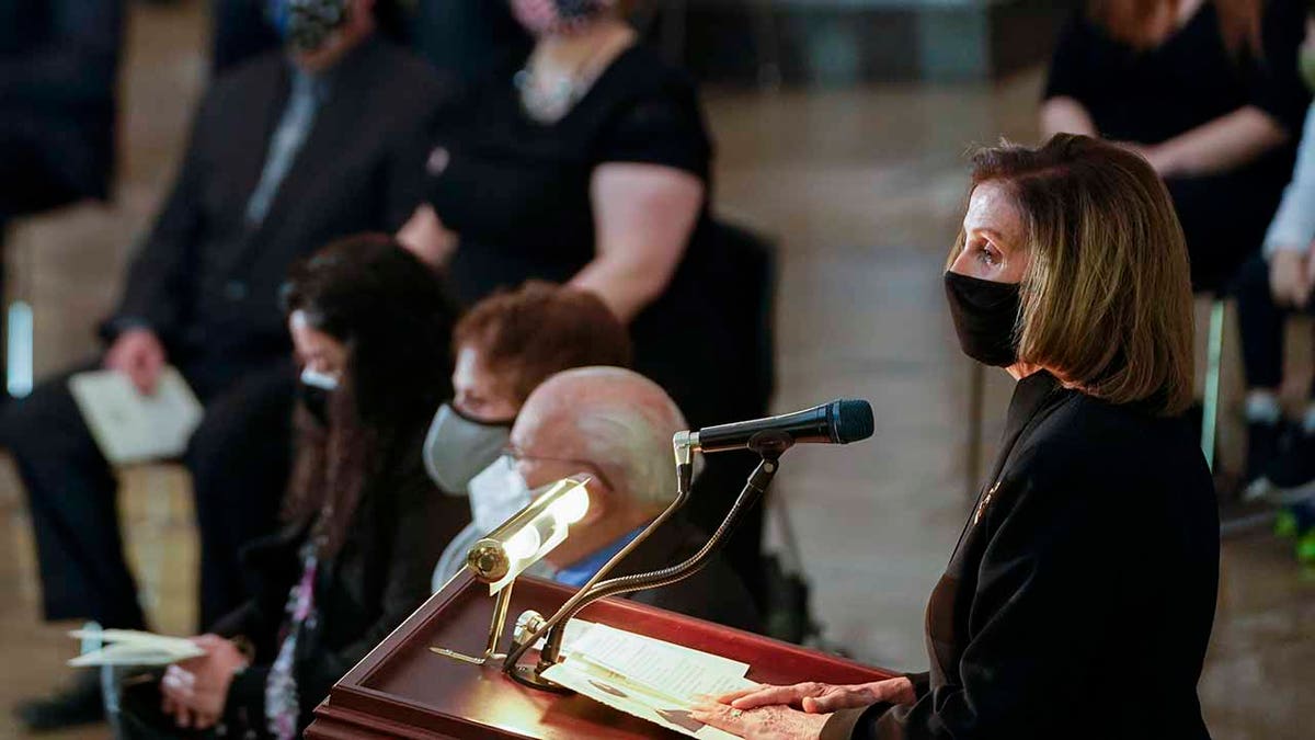 House Speaker Nancy Pelosi speaks during a ceremony memorializing U.S. Capitol Police officer Brian Sicknick, as an urn with his cremated remains lies in honor on a black-draped table at the center of the Capitol Rotunda, Wednesday, Feb. 3, 2021, in Washington. (Demetrius Freeman/The Washington Post via AP, Pool)