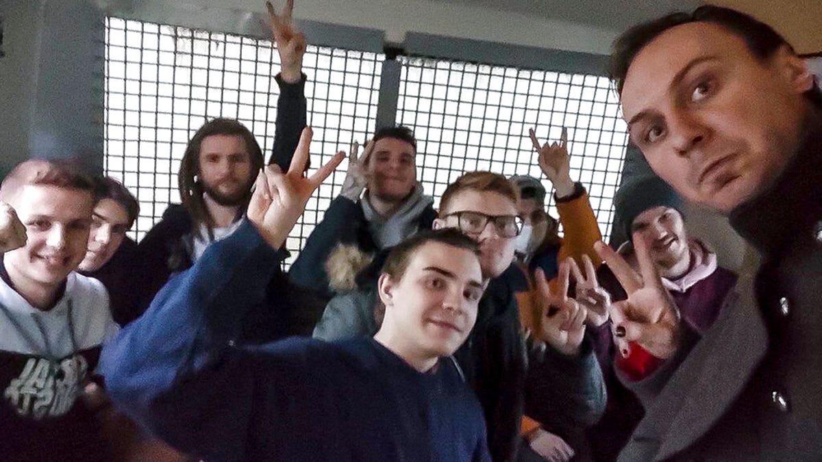 This photo released by Philipp Kyznetsov in his Instagram account philipp_kuznetsov, shows him, right, posing for a selfie with a group of detained people inside the police bus in Moscow, Russia, Wednesday, Jan. 27, 2021. Filipp Kuznetsov was arrested on Jan. 23, 2021 and sentenced to 10 days in jail on Jan. 25, 2021, but he didn't get into his jail cell until two nights later. Kuznetsov told the AP he spent the first night at a police precinct, and the second night in a police bus waiting for the detention center to accommodate him and about 20 others. (philipp_kuznetsov via AP)