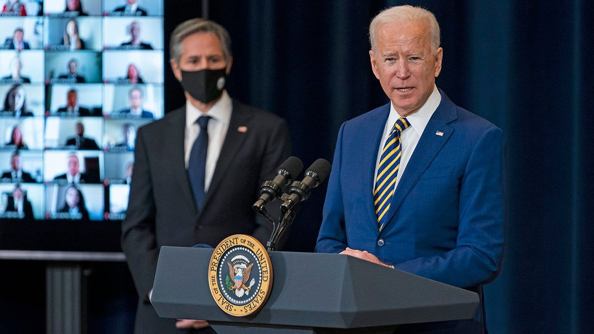 Secretary of State Antony Blinken listens as President Joe Biden delivers remarks to State Department staff, Thursday, Feb. 4, 2021, in Washington. (AP Photo/Evan Vucci)