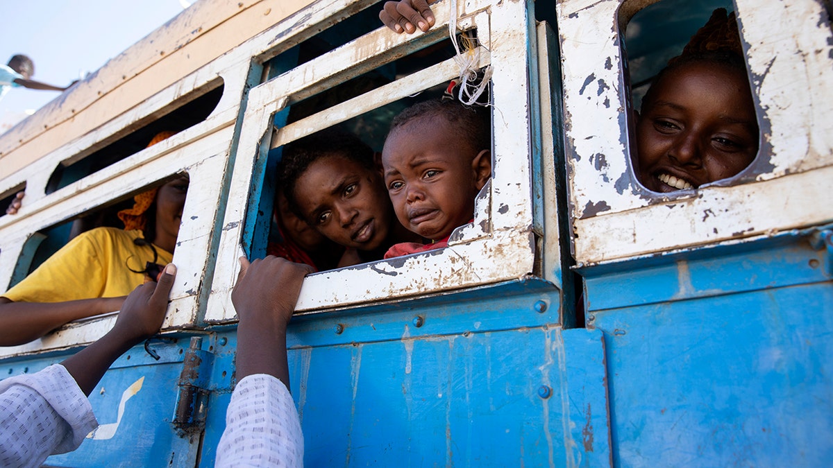 Refugees fleeing the conflict in Ethiopia's Tigray region ride a bus going to the Village 8 temporary shelter, near the Sudan-Ethiopia border, in Hamdayet, eastern Sudan, Dec. 1, 2020. (Associated Press)