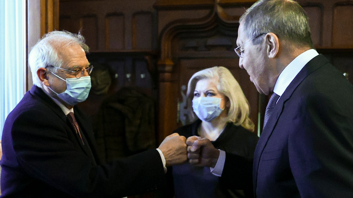 In this photo released by the Russian Foreign Ministry Press Service, Russian Foreign Minister Sergey Lavrov, right, and High Representative of the EU for Foreign Affairs and Security Policy Josep Borrell wearing a face mask to protect against coronavirus, greet each other prior to their talks in Moscow, Russia, Friday, Feb. 5, 2021. (Russian Foreign Ministry Press Service via AP)