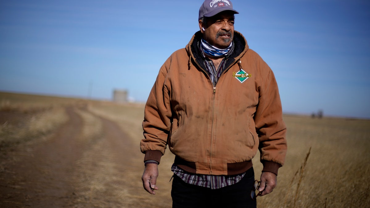 In this Jan. 13, 2021, file photo, Rod Bradshaw stands in a field of wheat on his farm near Jetmore, Kan. (AP Photo/Charlie Riedel File)