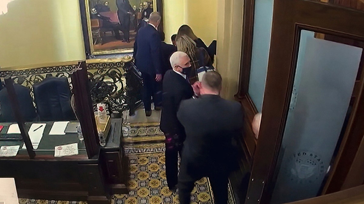 In this image from video, a security video shows Vice President Mike Pence being evacuated as rioters breach the Capitol. (Senate Television via AP)