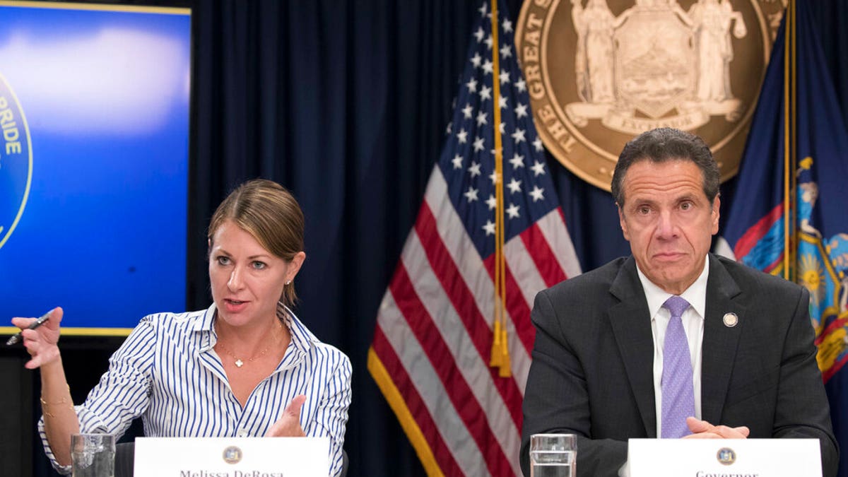 In this Sept. 14, 2018, file photo, Secretary to the Governor Melissa DeRosa is joined by New York Gov. Andrew Cuomo as she speaks to reporters during a news conference in New York. De Rosa, Cuomo's top aide, told top Democrats frustrated with the administration's long-delayed release of data about nursing home deaths that the administration "froze" over worries about what information was "going to be used against us," according to a Democratic lawmaker who attended the Wednesday, Feb. 10, 2021, meeting and a partial transcript provided by the governor's office. (AP Photo/Mary Altaffer, File)