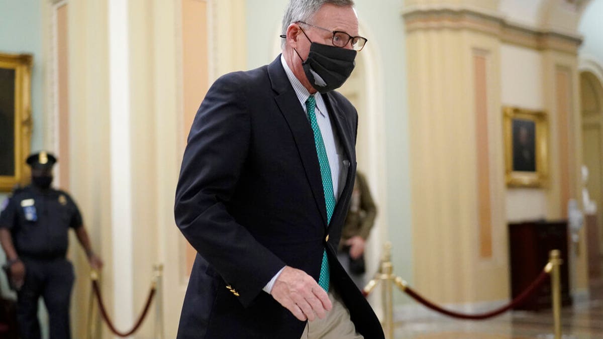 Sen. Richard Burr, R-N.C., walks in the Capitol as the Senate proceeds in a rare weekend session for final arguments in the second impeachment trial of former President Donald Trump, at the Capitol in Washington, Saturday, Feb. 13, 2021. (AP Photo/J. Scott Applewhite)