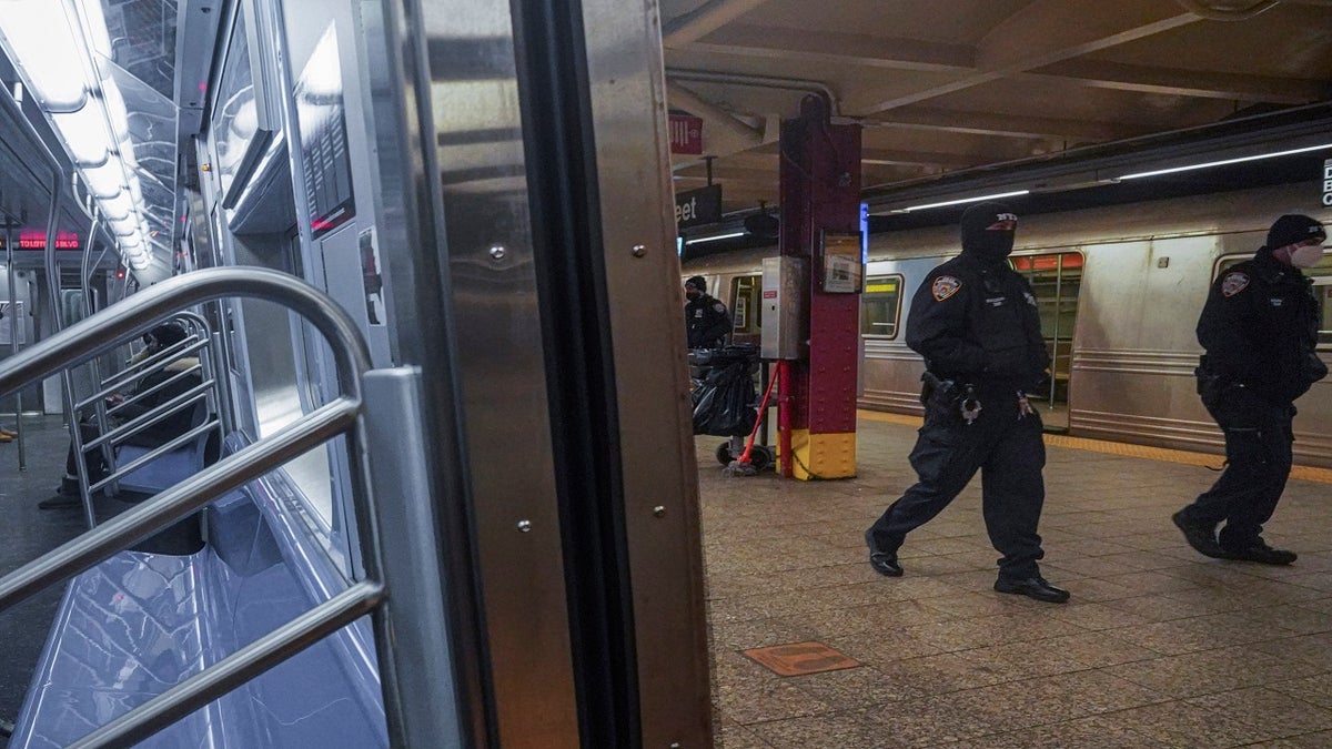 Police patrol the A line subway train bound to Inwood, after NYPD deployed an additional 500 officers into the subway system following deadly attacks, Saturday Feb. 13, 2021, in New York. (AP Photo/Bebeto Matthews)
