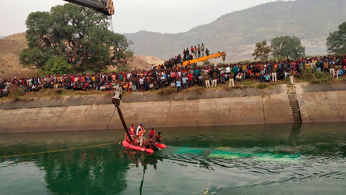 Rescuers work at the site of a bus accident in Sidhi district, in the central Indian state of Madhya Pradesh, Tuesday, Feb. 16, 2021. (Madhya Pradesh District Public Relation Office Sidhi via AP)