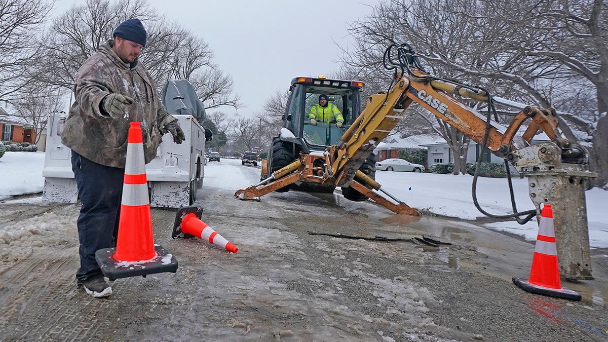 Workers in Richardson, Texas, prepare to work on a water main pipe that burst due to extreme cold in a neighborhood Wednesday, Feb. 17, 2021. (Associated Press)