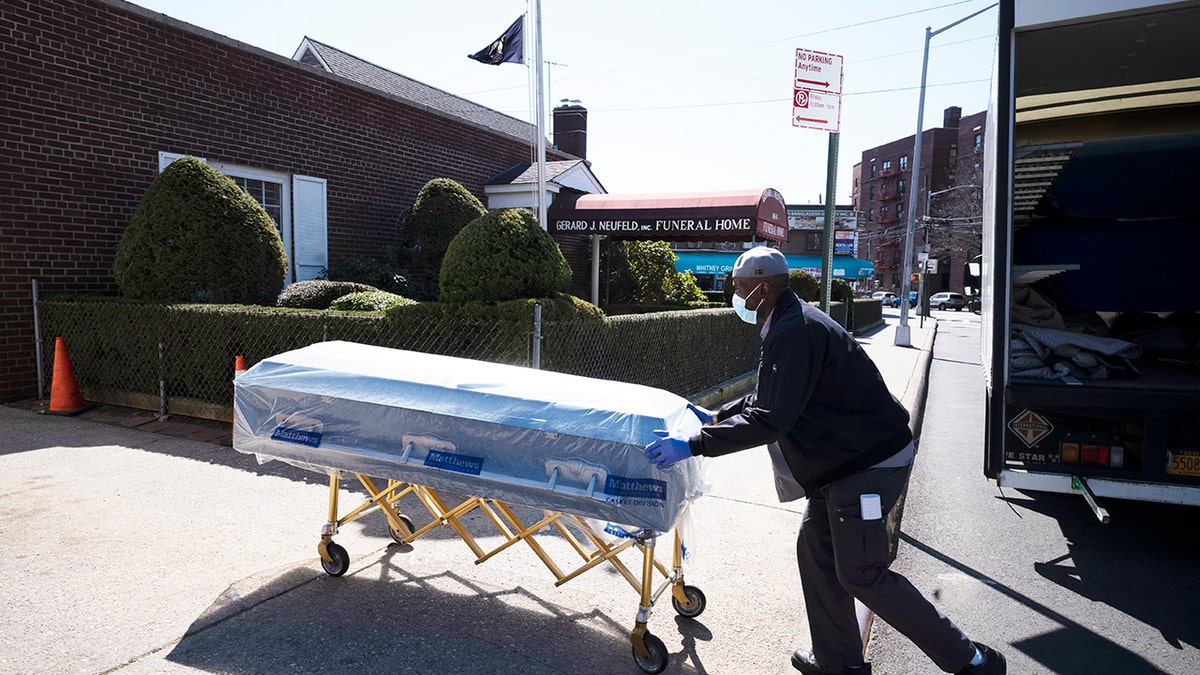 William Samuels delivers caskets to the Gerard Neufeld Funeral Home during the coronavirus pandemic in the Queens borough of New York on March 27, 2020. (AP Photo/Mark Lennihan)