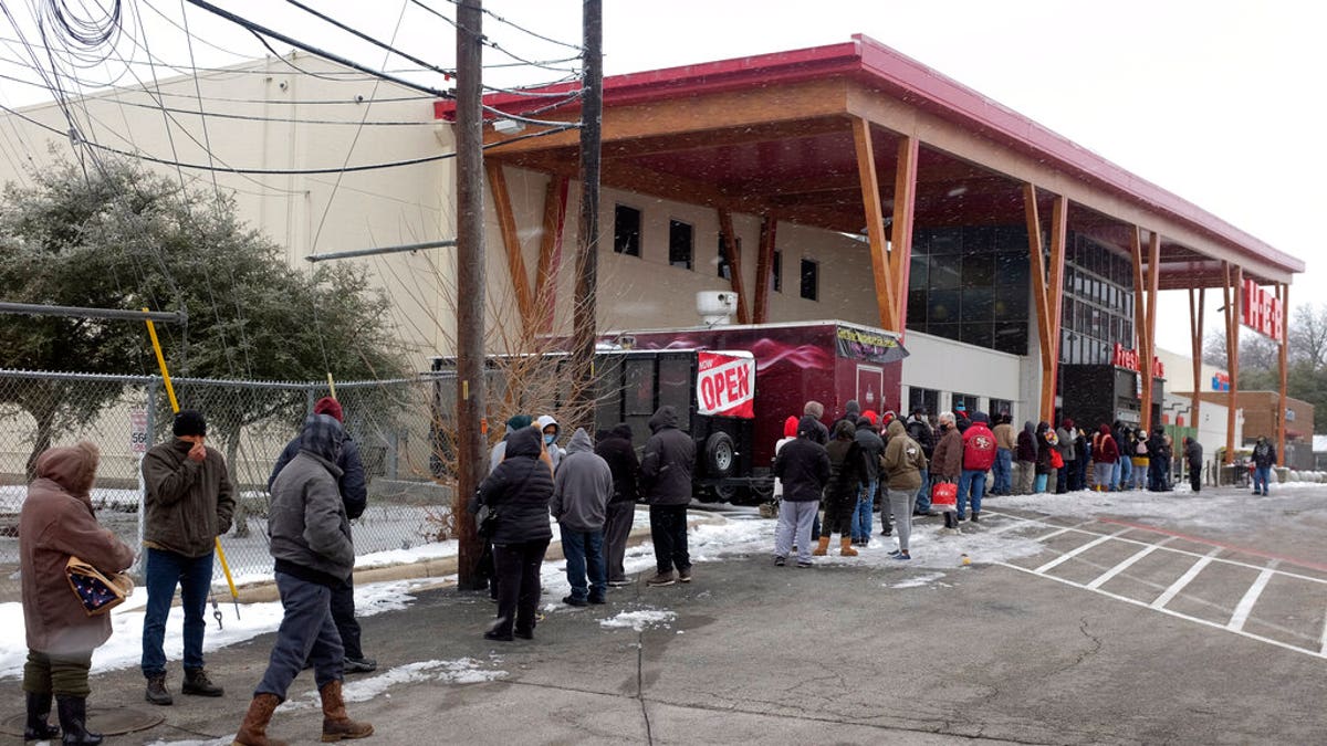 People stand in line outside an HEB grocery store in the snow Thursday, Feb. 18, 2021, in Austin, Texas. (Associated Press)