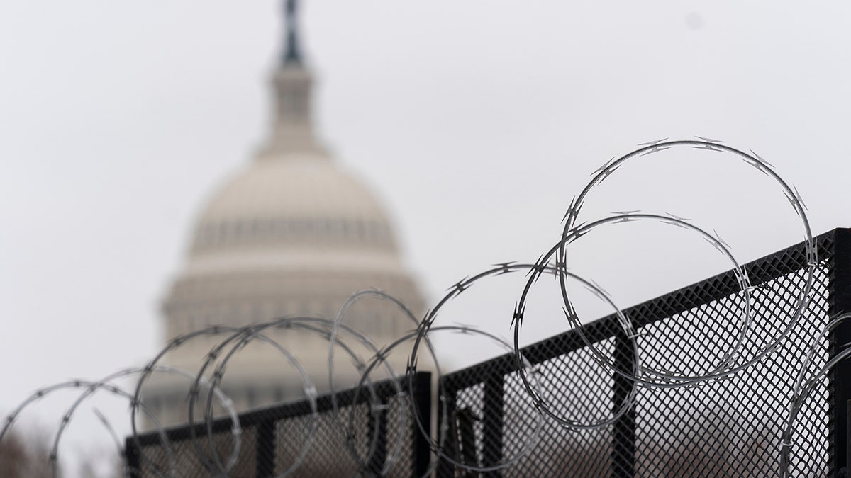 The U.S. Capitol is seen behind the razor fence around the U.S. Capitol, Thursday, Feb. 18, 2021. (Associated Press)