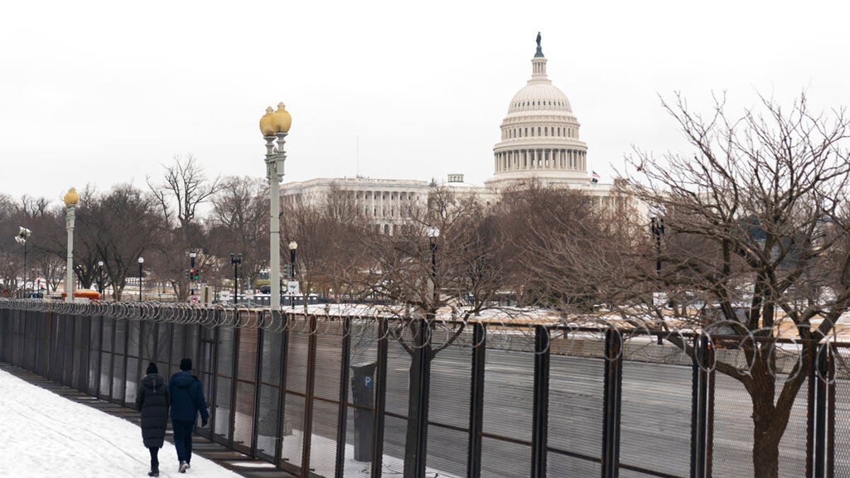 The U.S. Capitol is seen behind the metal security fencing around the U.S. Capitol, Thursday, Feb. 18, 2021.