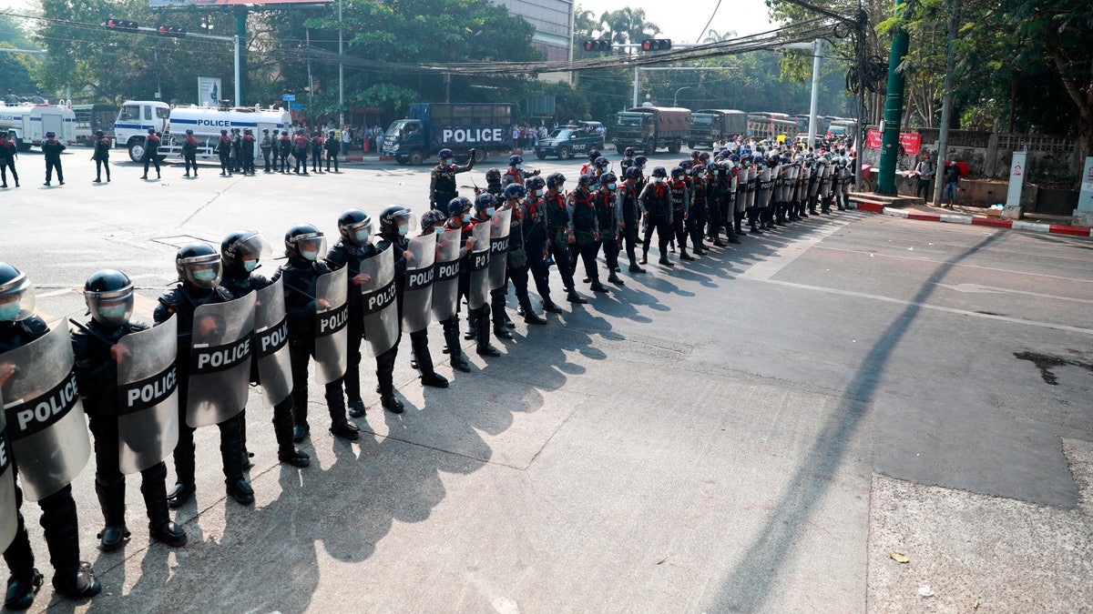Police security forces form a line to block a road near the U.S. embassy in Yangon, Burma Monday, Feb. 22, 2021. Protesters gathered in Burma's biggest city Monday despite the ruling junta's thinly veiled threat to use lethal force if people answered a call for a general strike opposing the military takeover three weeks ago. (AP Photo)