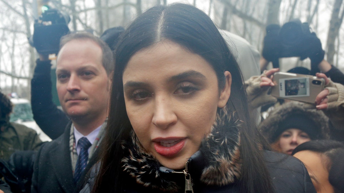 FILE - In this Feb. 12, 2019 file photo, Emma Coronel Aispuro, center, wife of Joaquin "El Chapo" Guzman, leaves federal court in New York. The wife of Mexican drug kingpin and escape artist Joaquin "El Chapo" Guzman has been arrested on international drug trafficking charges at an airport in Virginia. The Justice Department says 31-year-old Emma Coronel Aispuro, who is a dual citizen of the U.S. and Mexico, was arrested at Dulles International Airport on Monday and is expected to appear in federal court in Washington on Tuesday. (AP Photo/Seth Wenig)