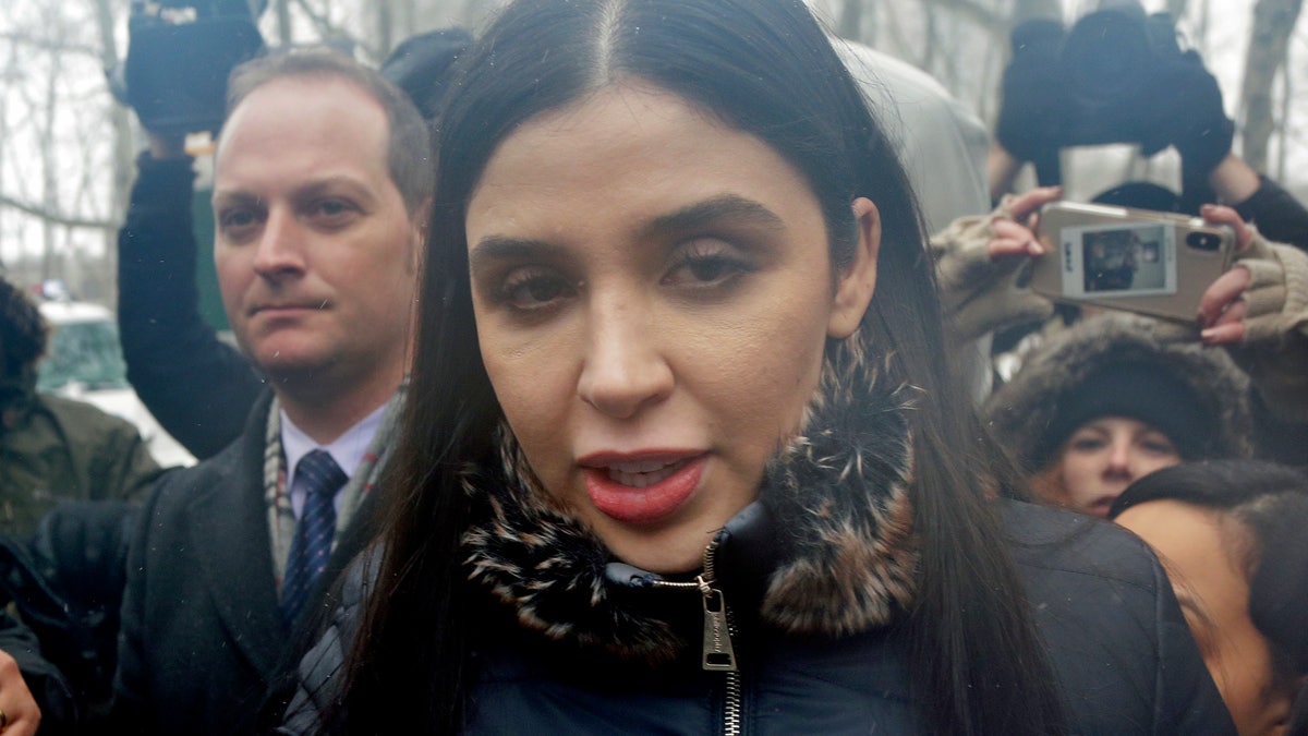 FILE - In this Feb. 12, 2019 file photo, Emma Coronel Aispuro, center, wife of Joaquin "El Chapo" Guzman, leaves federal court in New York. The wife of Mexican drug kingpin and escape artist Joaquin "El Chapo" Guzman has been arrested on international drug trafficking charges at an airport in Virginia. The Justice Department says 31-year-old Emma Coronel Aispuro, who is a dual citizen of the U.S. and Mexico, was arrested at Dulles International Airport on Monday and is expected to appear in federal court in Washington on Tuesday. (AP Photo/Seth Wenig)