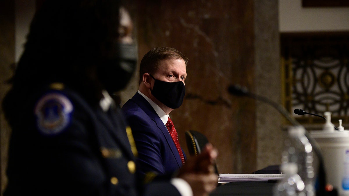 Capitol Police Capt. Carneysha Mendoza and former U.S. Capitol Police Chief Steven Sund appear before a Senate Homeland Security and Governmental Affairs & Senate Rules and Administration joint hearing on Capitol Hill, Washington, Tuesday, Feb. 23, 2021, to examine the January 6th attack on the Capitol. (Erin Scott/The New York Times via AP, Pool)