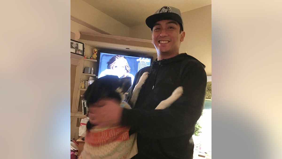 This Jan. 4, 2018 photo provided by Isabella Collins, Navy veteran Angelo Quinto smiles at his home in Berkeley, Calif. (Isabella Collins via AP)