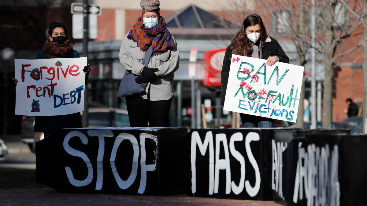 In this Wednesday, Jan. 13, 2021 file photo, Tenants' rights advocates demonstrate outside the JFK federal building in Boston. (AP Photo/Michael Dwyer)
