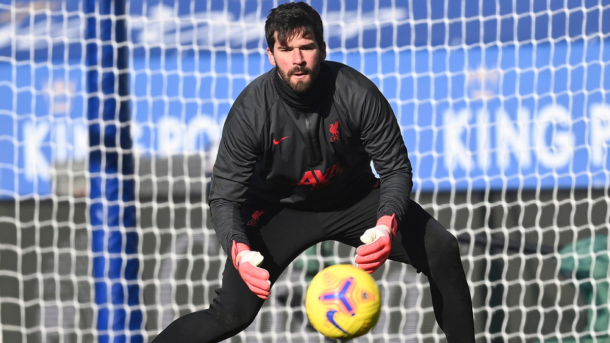 Liverpool's goalkeeper Alisson warms up ahead of the English Premier League soccer match between Leicester City and Liverpool at the King Power Stadium in Leicester, England, Saturday, Feb. 13, 2021. (Michael Regan/Pool Photo via AP)