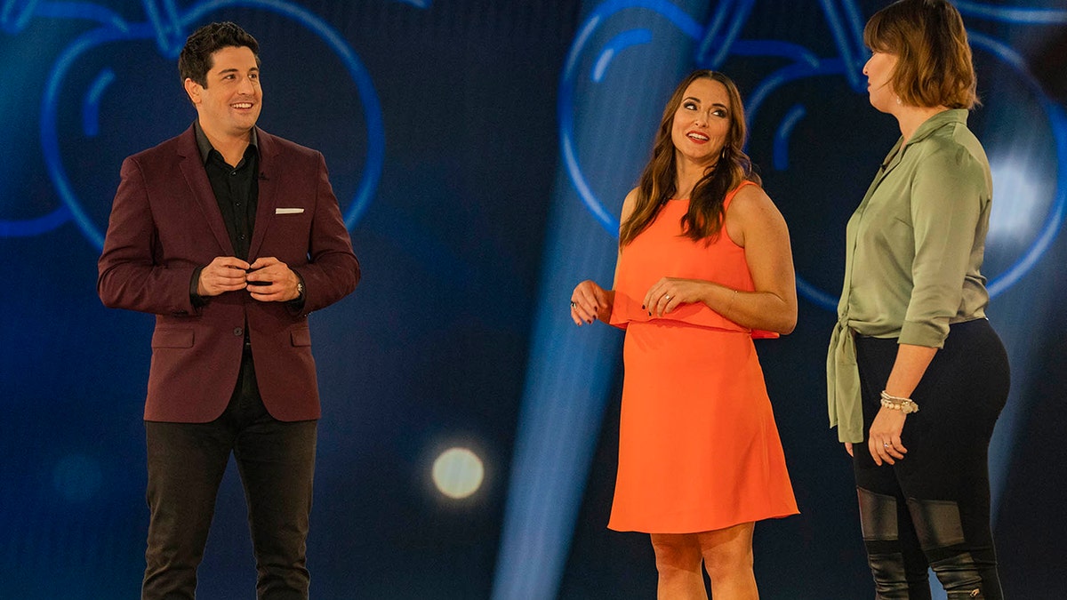 L-R: Host Jason Biggs with contestants Cara and Gwen in an episode of "Cherries Wild.'