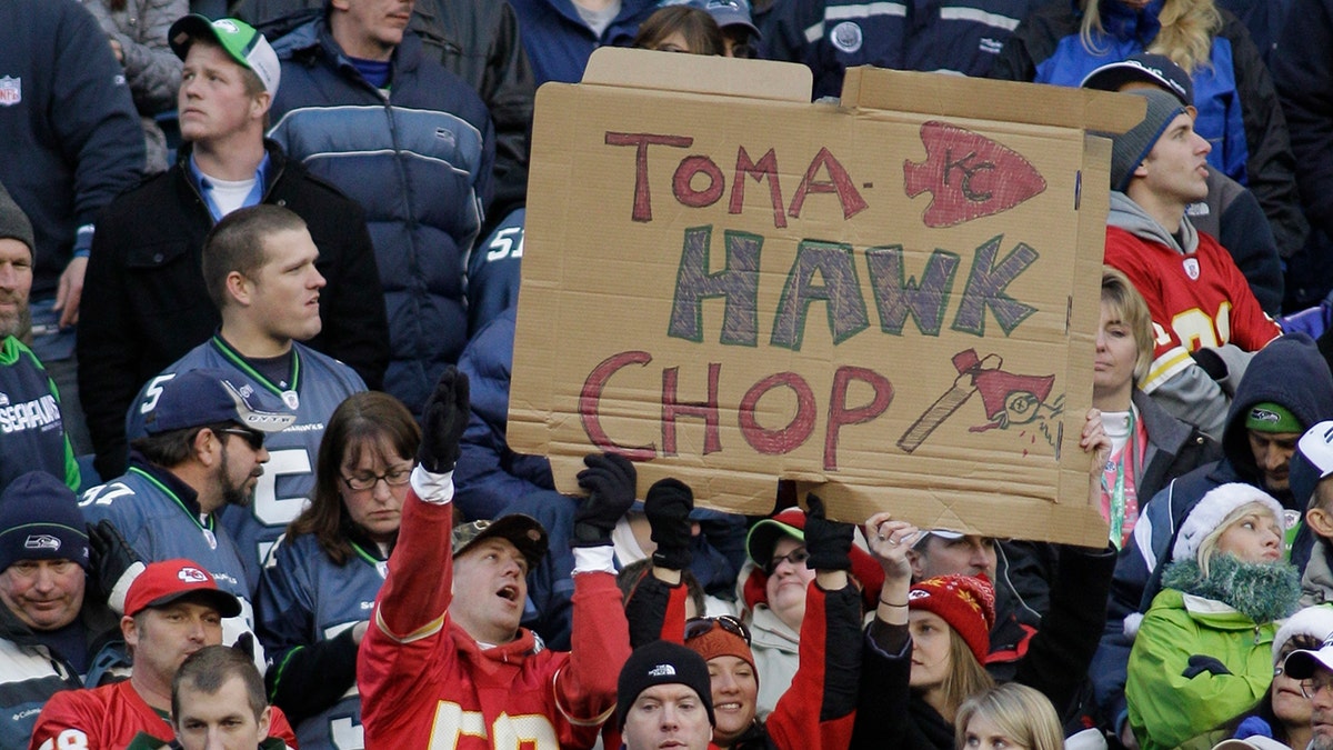 FILE - In this Nov. 28, 2010, file photo, Kansas City Chiefs fans hold a sign that reads "TomaHAWK Chop," during an NFL football game between the Chiefs and the Seattle Seahawks in Seattle. (AP Photo/Ted S. Warren, File)