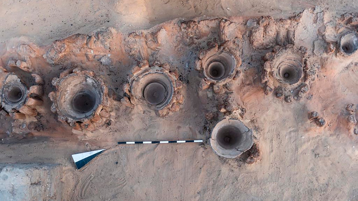 This photo provided by the Egyptian Antiquities Ministry shows pottery basins used to heat up a mixture of grains and water to produce beer, archaeologists say.