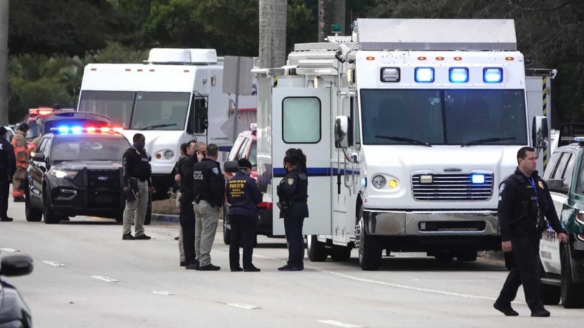 Law enforcement gathers near the scene of a shooting that wounded several FBI agents in Sunrise, Fla., Tuesday, Feb. 2, 2021. (Joe Cavaretta/South Florida Sun-Sentinel via AP)