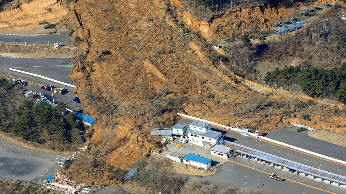 A landslide caused by a strong earthquake covers a circuit course in Nihonmatsu city, Fukushima prefecture, northeastern Japan, Sunday, Feb. 14, 2021. (Associated Press)