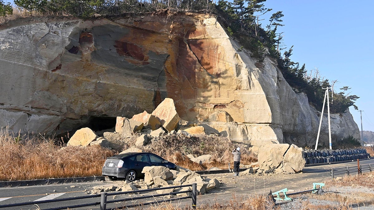 Collapsed rocks block a road after a strong earthquake hit Soma city, Fukushima prefecture, northeastern Japan, Sunday, Feb. 14, 2021. (Associated Press)