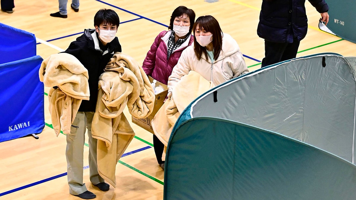 Evacuees shelter at a gym as an earthquake hit the area, in Soma, Fukushima prefecture, northeastern Japan, Sunday, Feb. 14, 2021. (Associated Press)