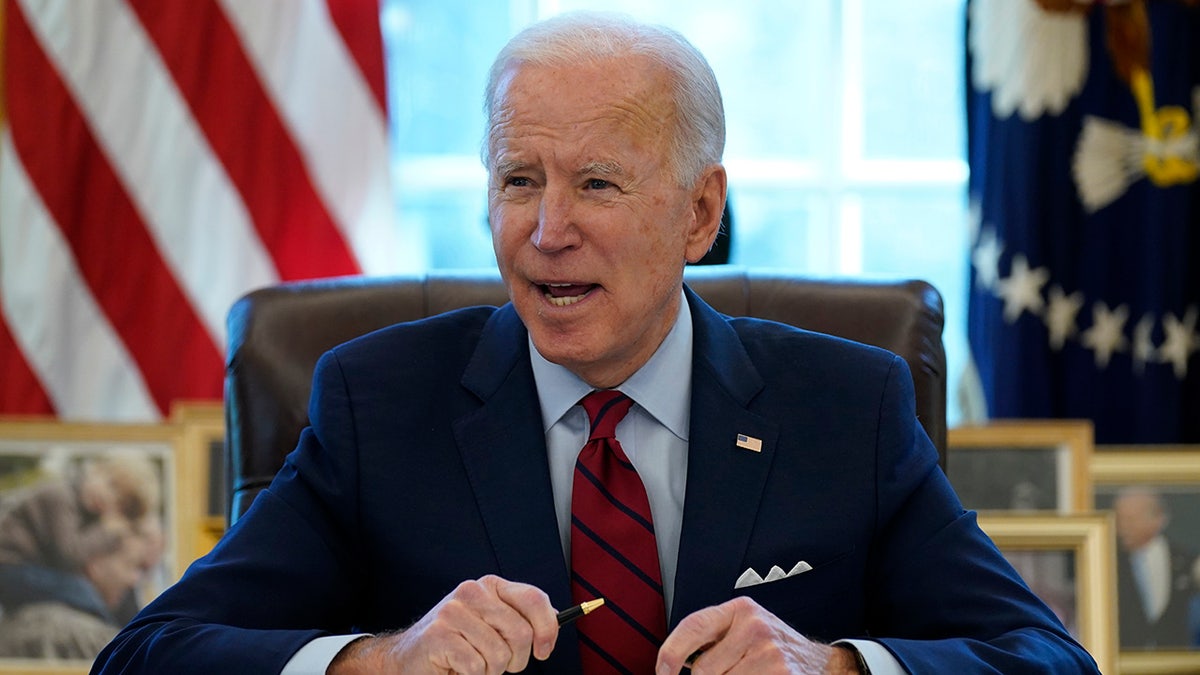 President Joe Biden signs a series of executive orders on health care, in the Oval Office of the White House, Thursday, Jan. 28, 2021, in Washington. (AP Photo/Evan Vucci)