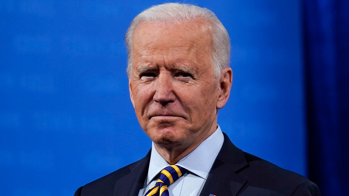 President Joe Biden stands on stage during a break in a televised town hall event at Pabst Theater, Tuesday, Feb. 16, 2021, in Milwaukee. (AP Photo/Evan Vucci)