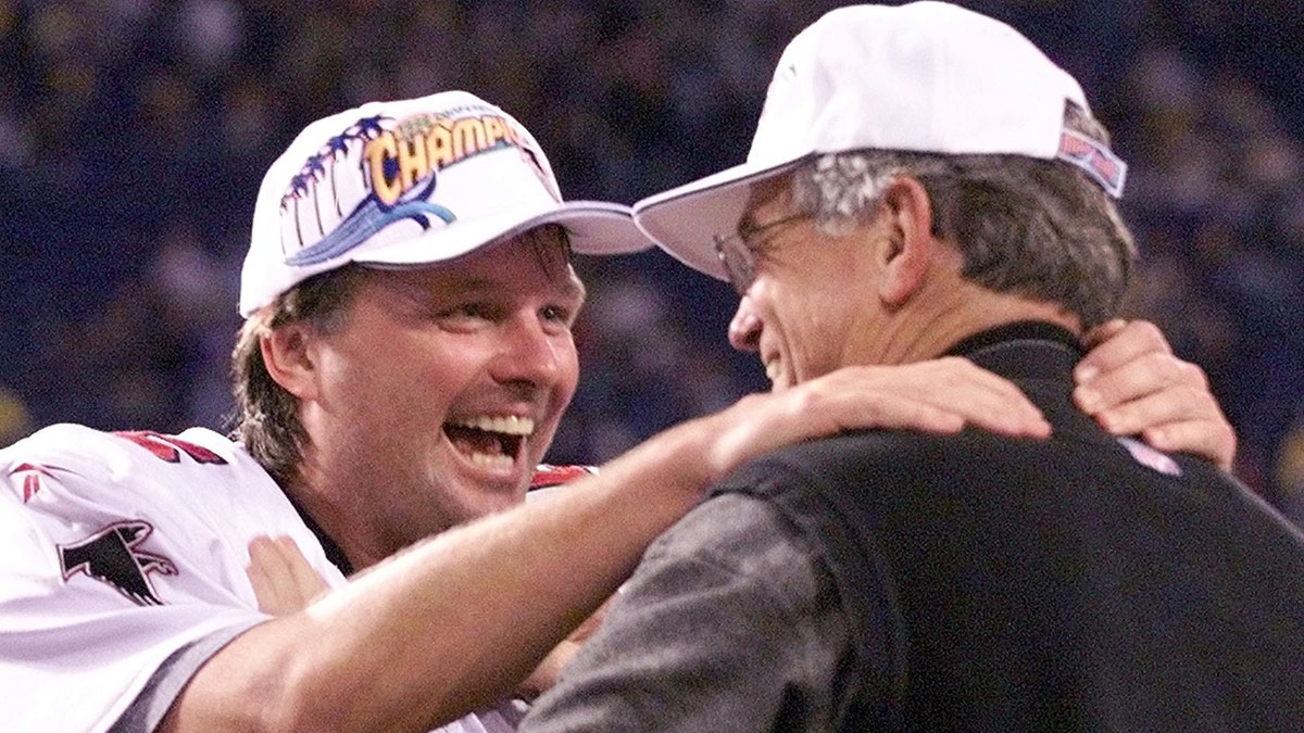 Kicker Morten Andersen (L) of the Atlanta Falcons hugs head coach Dan Reeves after making the winning 38-yard field goal in overtime against the Minnesota Vikings in the NFC Championship game 17 January at the Hubert H. Humphrey Metrodome in Minneapolis, MN. The Falcons won the game 30-27. (Photo by JEFF HAYNES / AFP)