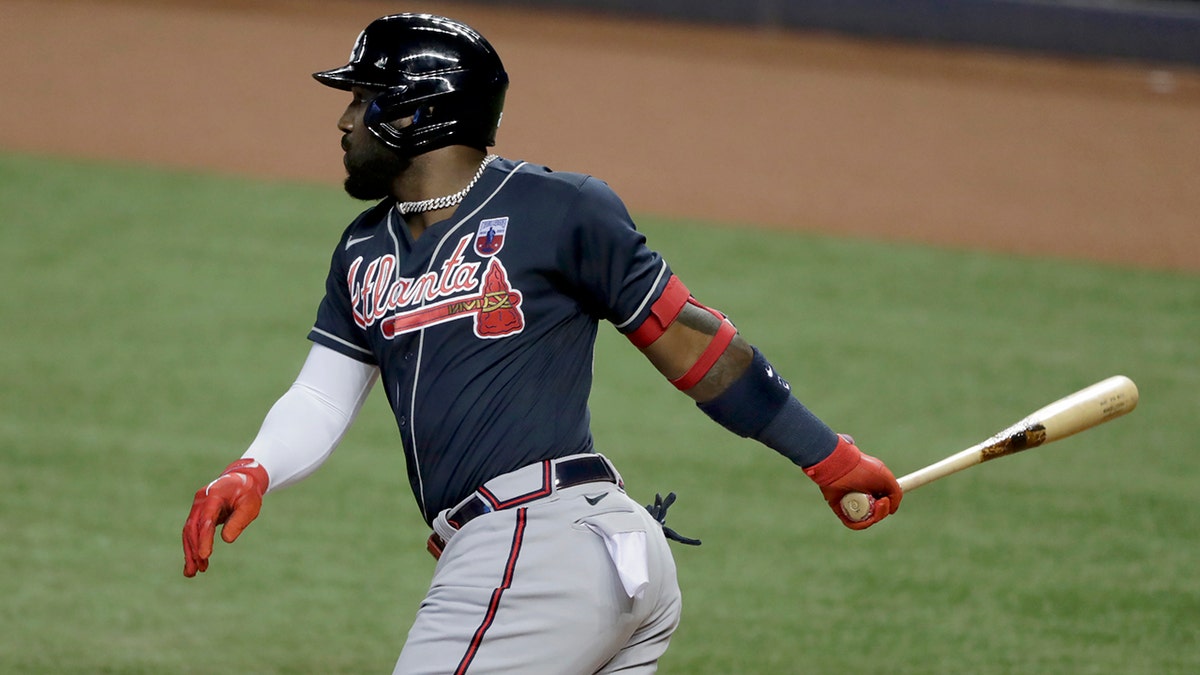 In this Aug. 16, 2020, file photo, Atlanta Braves' Marcell Ozuna watches his single during the first inning of a baseball game against the Miami Marlins in Miami.