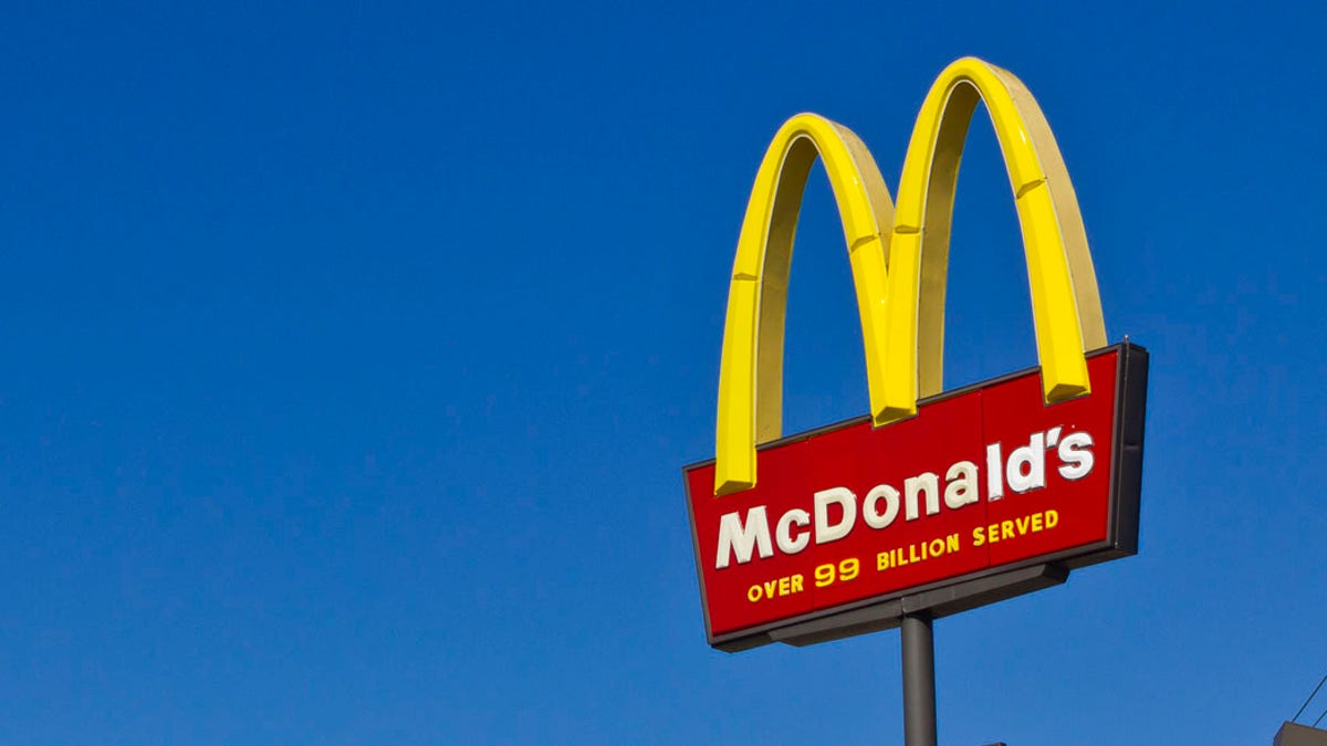 McDonald's arches sign against a blue sky