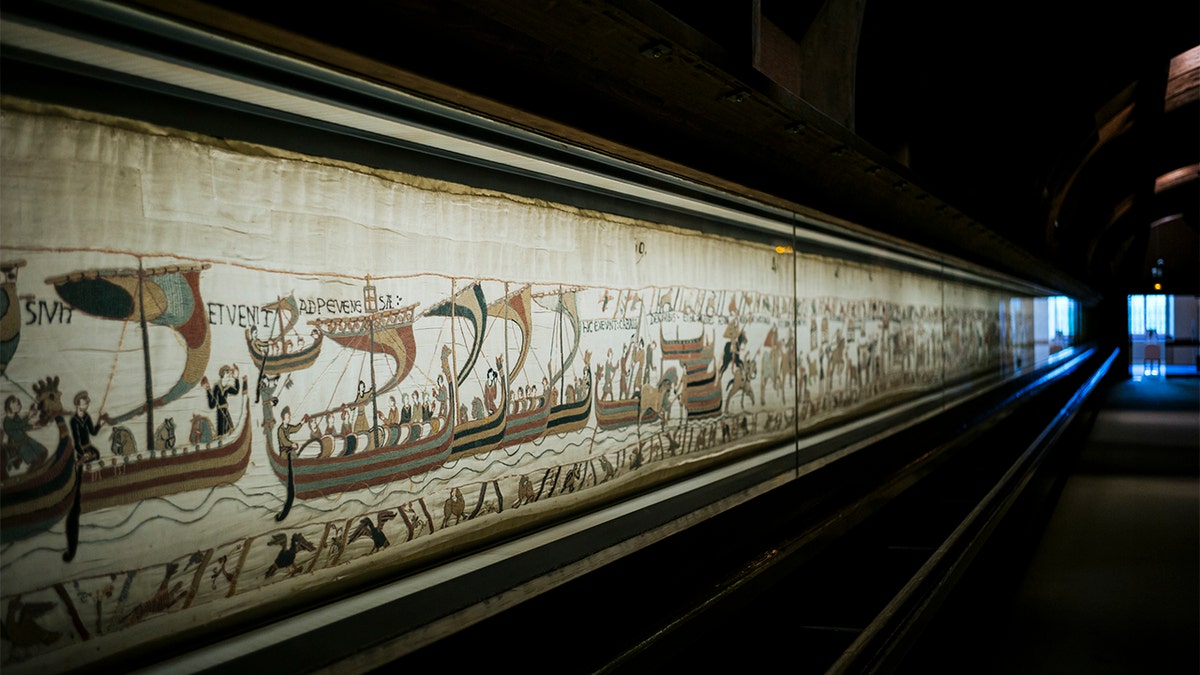 This file photo taken, Sept. 18, 2019 shows a large part of the 11th century Bayeux tapestry chronicling the Norman conquest of England, in Bayeux, Normandy, France. (AP Photo/Kamil Zihnioglu, File)