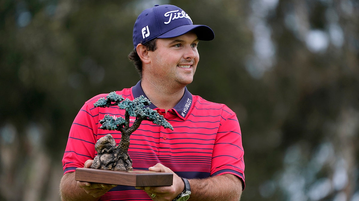 Patrick Reed with trophy