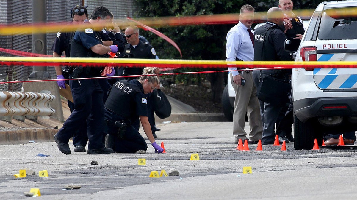 Chicago police officers investigate an officer-involved shooting outside the department's 25th district station on July 30, 2020. According to police, a prisoner was shot and and two officers were wounded. (Antonio Perez/Chicago Tribune/Tribune News Service via Getty Images)