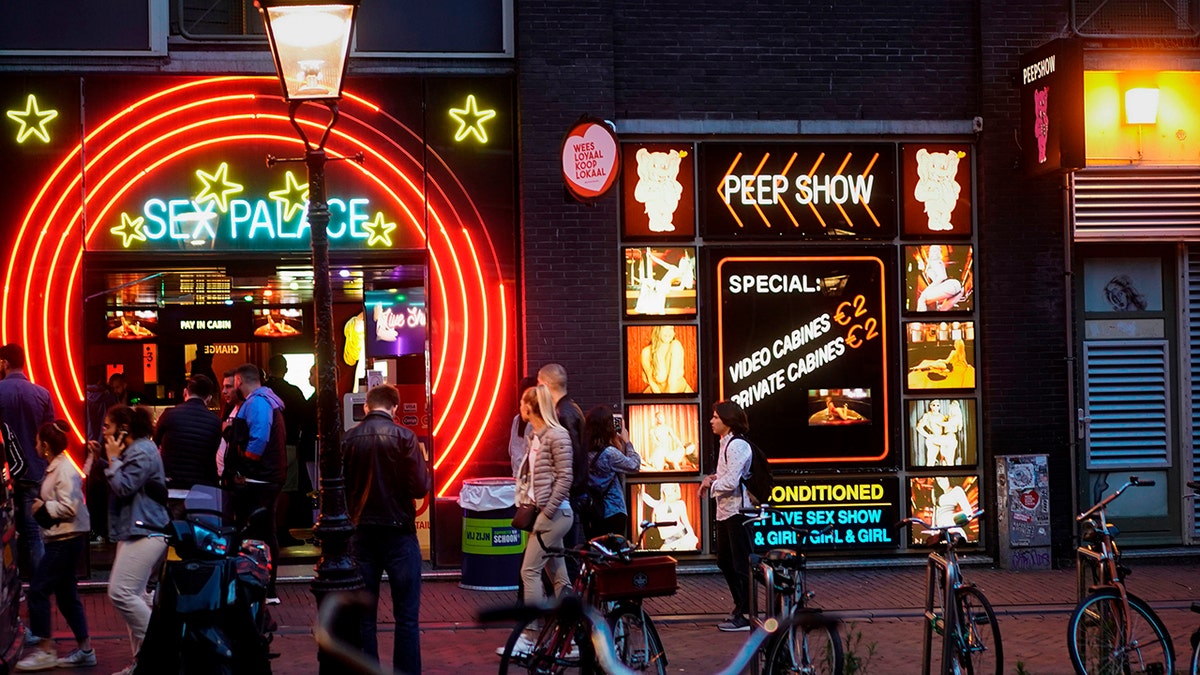 Visitors crowd the red-light district in Amsterdaym after Dutch brothels were allowed to reopen in July following coronavirus shutdowns.