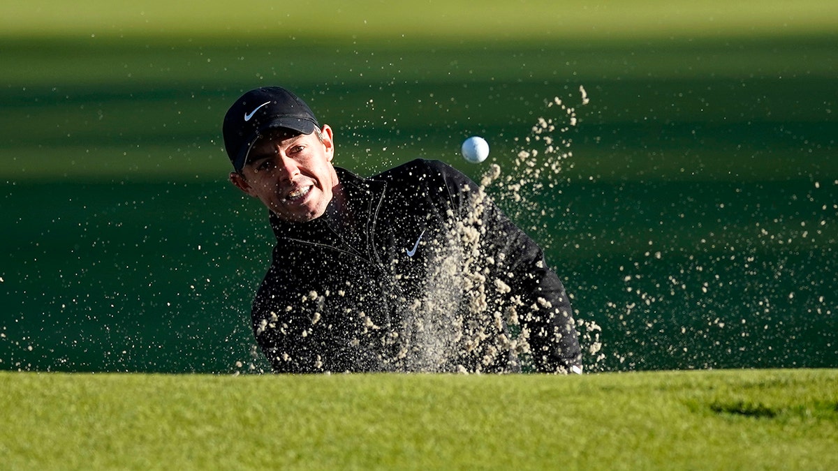 Rory McIlroy, of Northern Ireland, hits out of the bunker onto the third green during the Genesis Invitational pro-am golf event at Riviera Country Club, Wednesday, Feb. 17, 2021, in the Pacific Palisades area of Los Angeles. (AP Photo/Ryan Kang)