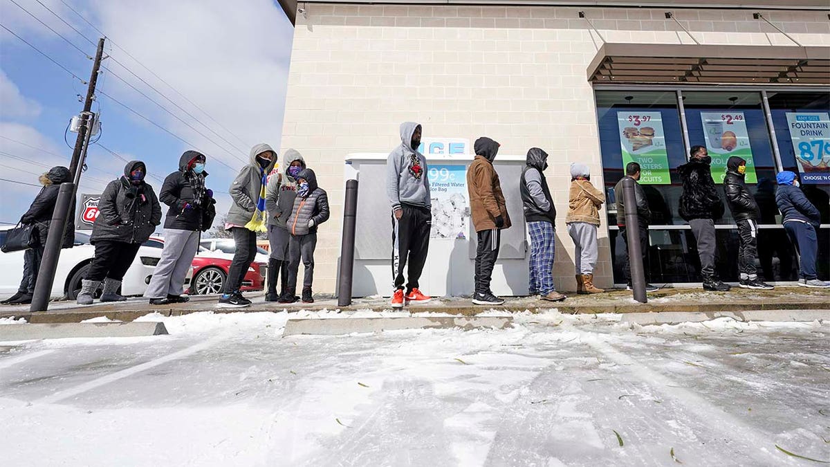 People wait in line to purchase groceries Monday, Feb. 15, 2021, in Houston.