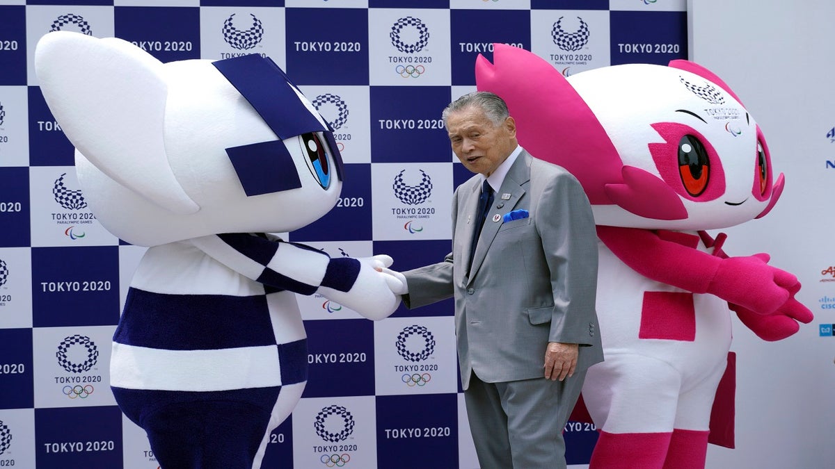 Tokyo Olympic mascot "Miraitowa," left, and Paralympic mascot "Someity," right, and Tokyo Olympic Organizing Committee President Yoshiro Mori on-stage during the mascots' debut event in Tokyo in 2018. (AP)