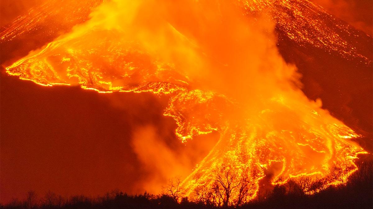 A fiery river of glowing lava flows on the north-east side of the Mt Etna volcano near Milo, Sicily, Wednesday night, Feb. 24, 2021. (AP Photo/Salvatore Allegra)