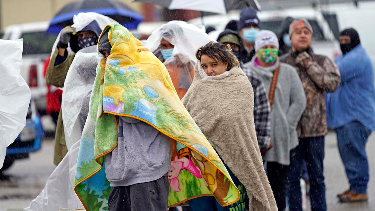 Customers waited over an hour in the freezing rain to fill their tanks.  (AP Photo/David J. Phillip)