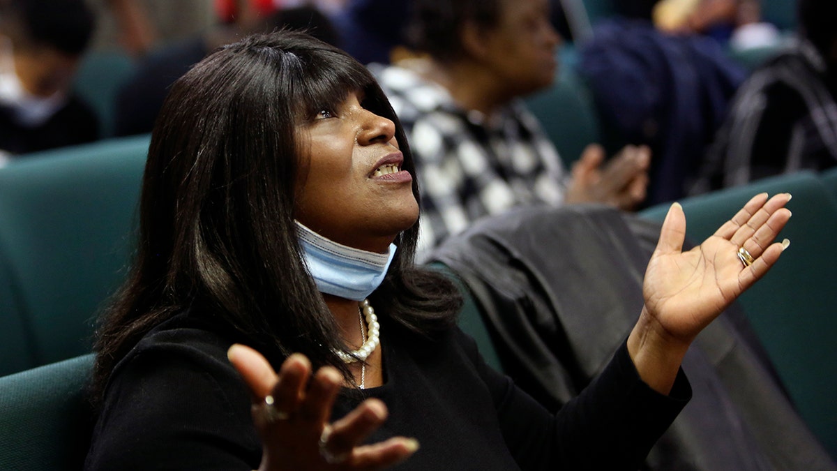 A congregant of the Faith Center Church lifts her hands toward the sky as she worships with others in Bluefield, W.Va., on Saturday, Jan. 24, 2021. (AP Photo/Jessie Wardarski)