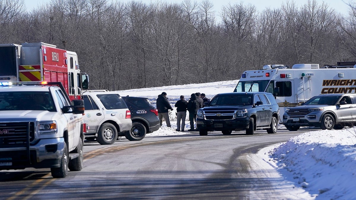 Law enforcement personnel and first responders gather outside of the Allina Health clinic Tuesday. (AP/Star Tribune)