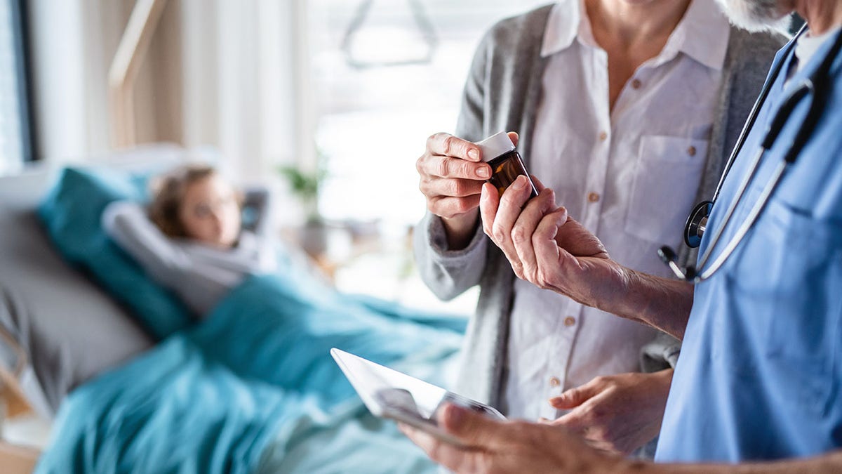 A mother of a hospitalized girl talks to a doctor in a hospital.