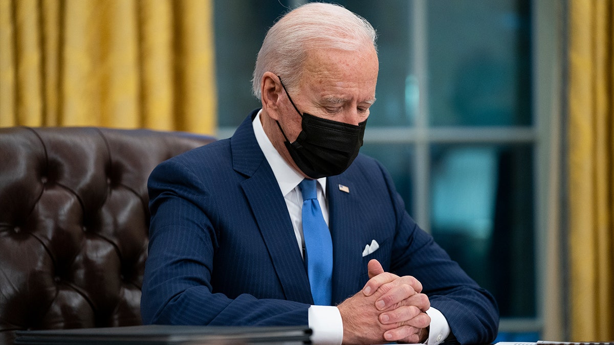 President Joe Biden looks down as he talks about the FBI agents killed in Sunrise, Fla., during an event on immigration in the Oval Office of the White House, Tuesday, Feb. 2, 2021, in Washington. (AP Photo/Evan Vucci)