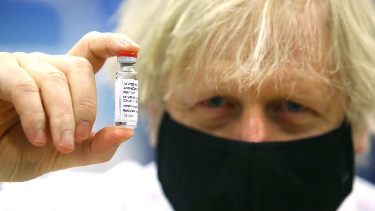 FILE - In this Wednesday, Feb. 17, 2021 file photo, Britain's Prime Minister Boris Johnson holds a vial of the Oxford/Astra Zeneca Covid-19 vaccine at a vaccination center in Cwmbran, South Wales. (Geoff Caddick/Pool via AP, File)
