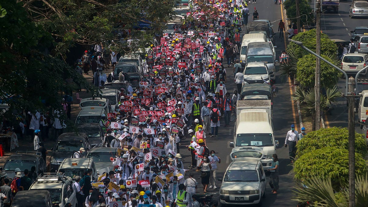 Anti-coup protesters march in Yangon, Burma, on Thursday. (AP Photo)